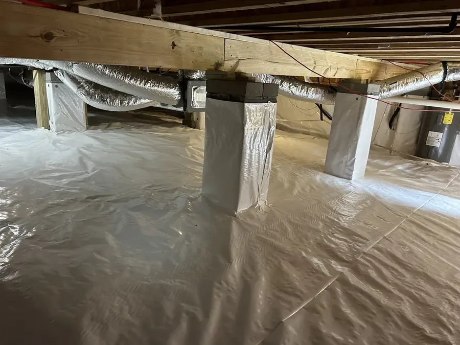 Standing water and wet insulation in the crawl space of an Easley, SC home