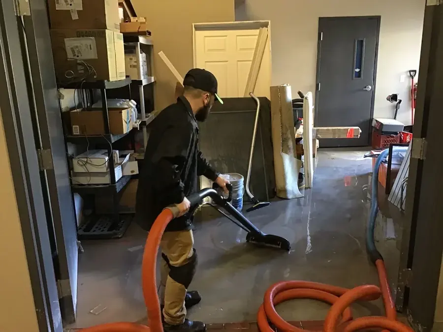 Technician extracting standing water from a flooded Easley, SC home floor