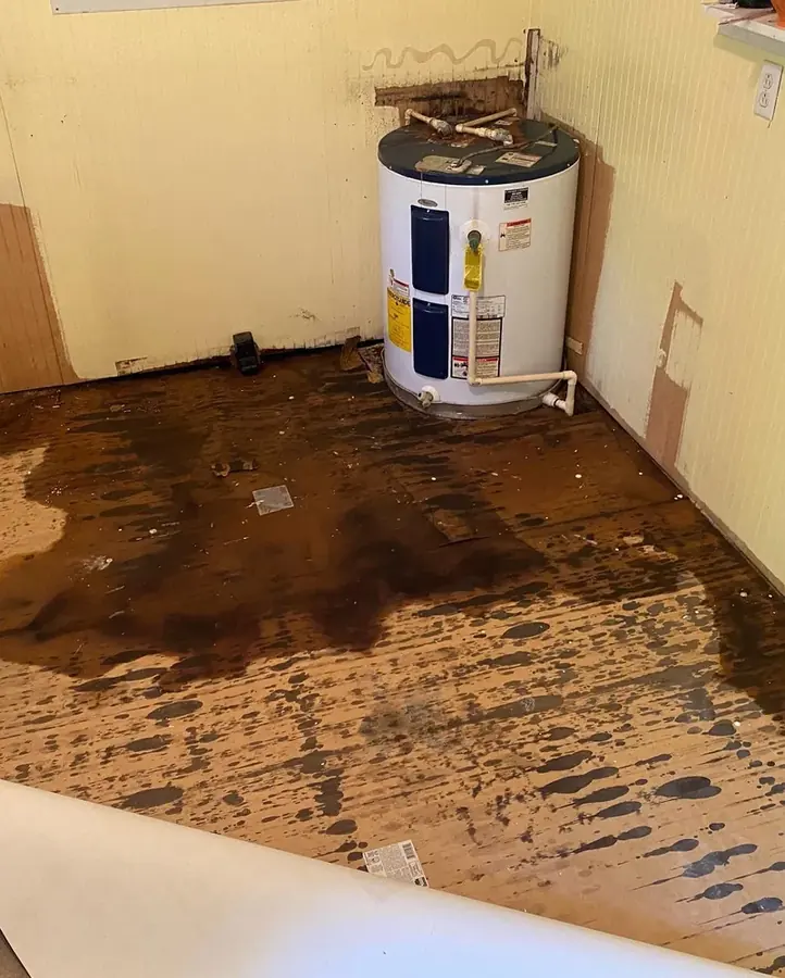 Failed water heater tank leaking across a garage floor in an Easley, SC home